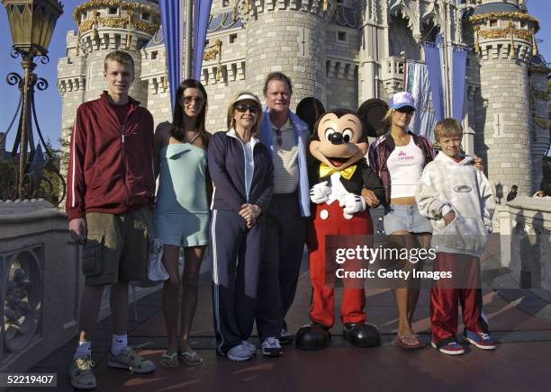 In this handout image provided by Walt Disney World, the Hilton family, Conrad, Nicky, parents Kathy and Rick, Paris and Barron pose with Mickey...