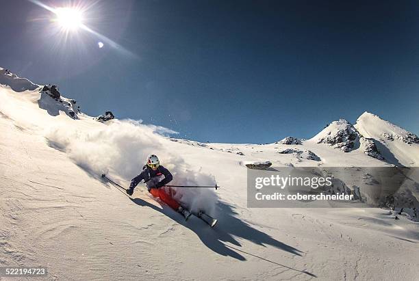 austria, skier doing turn in fresh powder snow - 高山滑雪 個照片及圖片檔