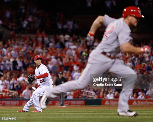 Matt Bowman of the St. Louis Cardinals prepares to throw to first for the final out of of the game against Jordan Pacheco of the Cincinnati Reds at...