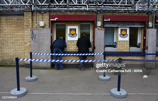 Fan collect their tickets at the stadium before the Emirates FA Cup Sixth Round Replay match between West Ham United and Manchester United at Boleyn...