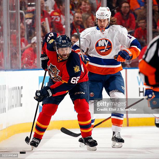 Jaromir Jagr of the Florida Panthers skates with the puck against Matt Martin of the New York Islanders in Game One of the Eastern Conference...