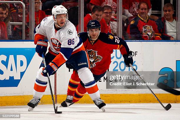 Nikolay Kulemin of the New York Islanders skates with the puck against Rocco Grimaldi of the Florida Panthers in Game One of the Eastern Conference...