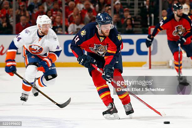 Jonathan Huberdeau of the Florida Panthers skates with the puck against Thomas Hickey of the New York Islanders in Game One of the Eastern Conference...