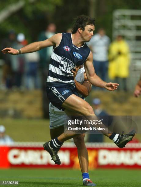 Mathew Scarlett of Geelong kicks during the round one AFL Wizard Cup match between the Kangaroos and the Geelong Cats at Manuka Oval on February 20,...