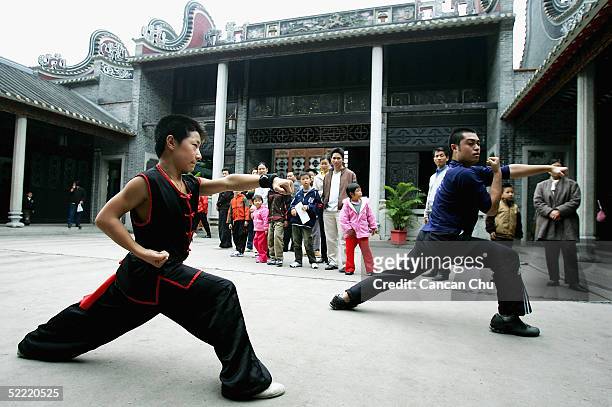 Member of "Huang Feihong" martial arts team teaches Kung Fu to a visitor at the Huang Feihong Memorial Hall on February 18, 2005 in Foshan, Guangdong...