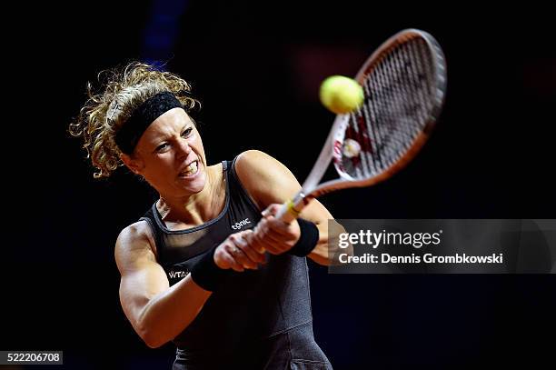 Laura Siegemund of Germany plays a backhand in her match against Polona Hercog of Slovenia during Day 1 of the Porsche Tennis Grand Prix at...