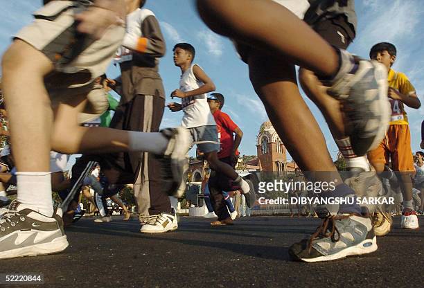 Indian runners take part in a marathon organised to raise fund for HIV/AIDS patients, in Madras 20 February 2005. Non Governmental Organisation...