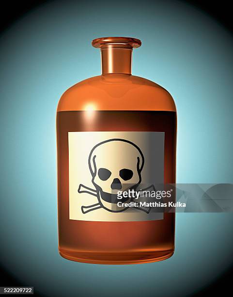 skull and crossbones on a glass bottle - toxin stockfoto's en -beelden