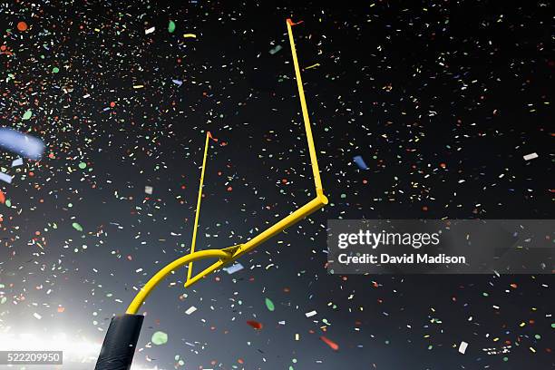 american football stadium goalpost and confetti - palo della porta foto e immagini stock