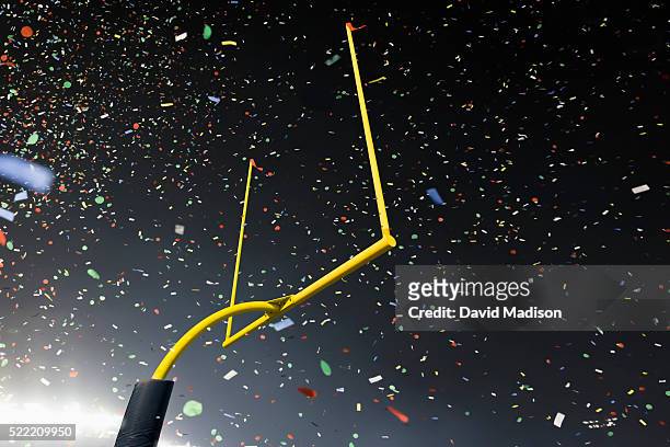 american football stadium goalpost and confetti - american football field stock pictures, royalty-free photos & images