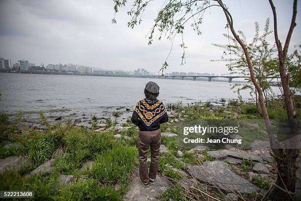 Kim Jeong-ok a singer and a part-time cleaner, and an actress in the upcoming documentary film about Dilkusha House, practices singing on the bank of...
