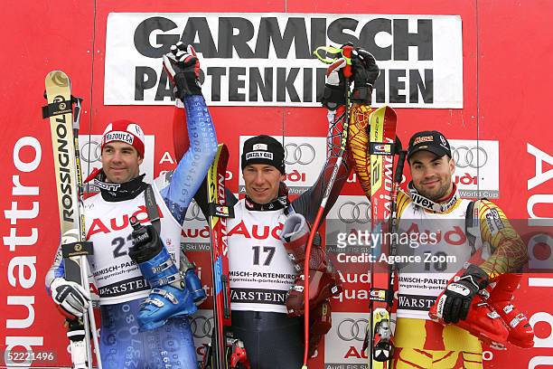 Didier Defago of Switzerland, second place, Christoph Gruber of Austria, first place, and Francois Bourque of Canada, third place, celebrate on the...