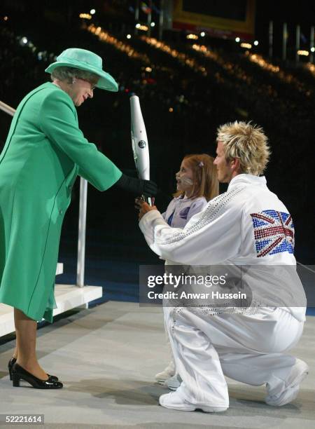 England captain David Beckham and Kirsty Howard hand the Queen's Jubille baton to Queen Elizabeth II after its final leg around the city of...