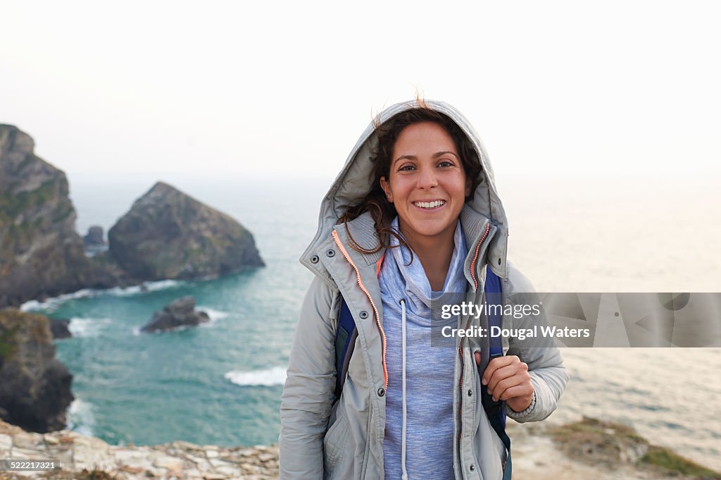 Portrait of woman on rocky coastline.