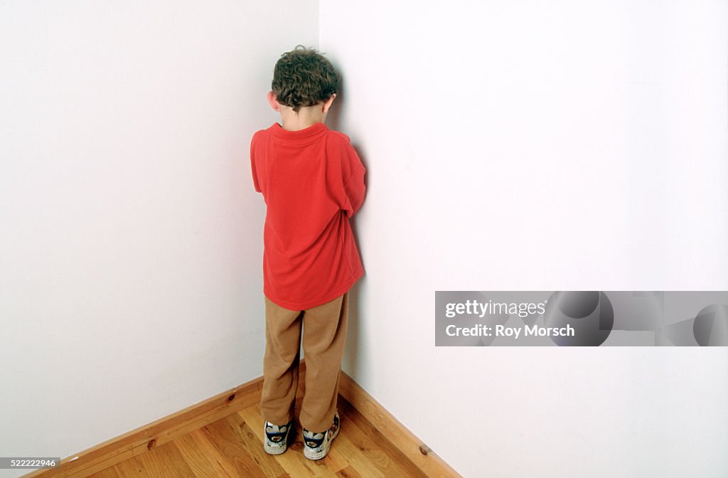 Child Being Punished by Standing in the Corner