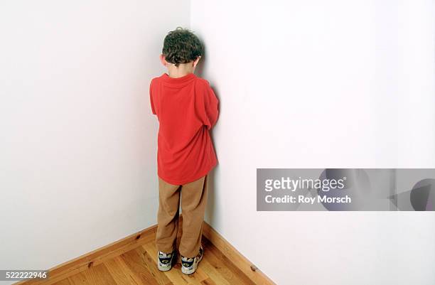 child being punished by standing in the corner - 罰 ストックフォトと画像