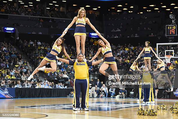 The West Virginia Mountaineers cheerleaders perform on the floor during the first round of the 2016 NCAA Men's Basketball Tournament against the...