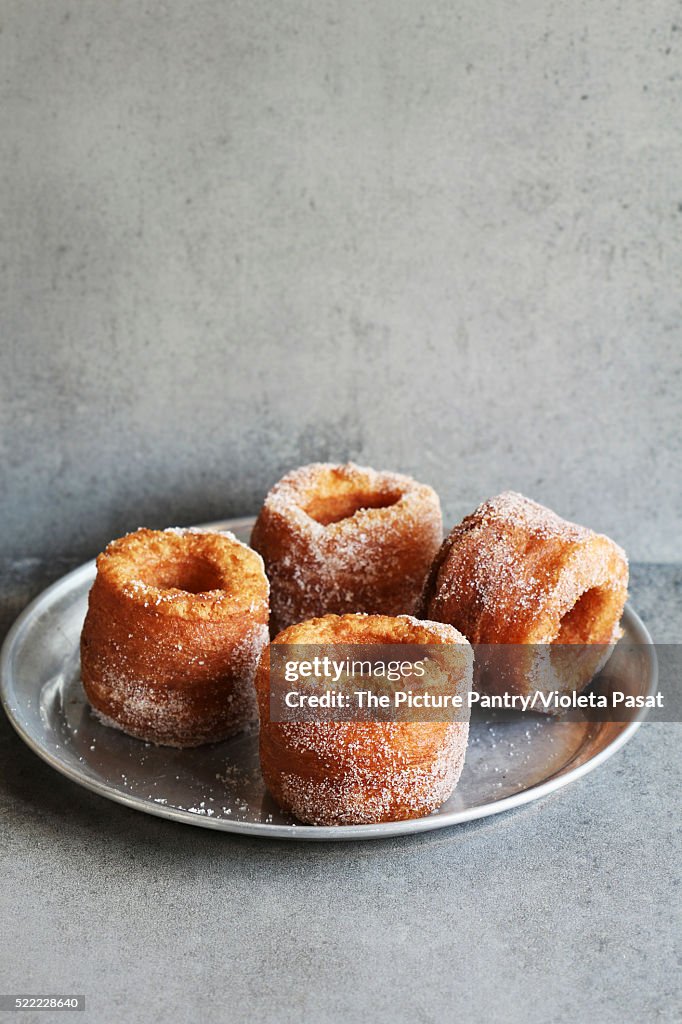 Fried cronut on an aluminum plate.Croissant and doughnut mixture.