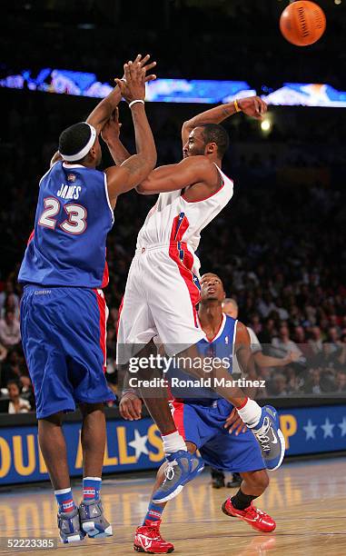 Kobe Bryant of the Western Conference All-Stars makes a behind the back pass away from LeBron James of the Eastern Conference All-Stars during the...