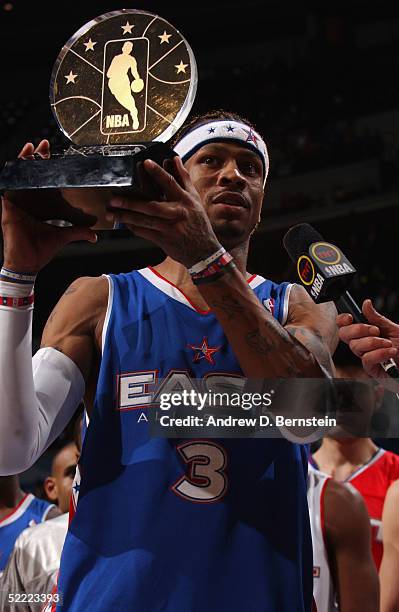 Allen Iverson of the Eastern Conference All-Stars holds up the MVP trophy as the East won 125-115 over the Western Conference in the 54th All-Star...