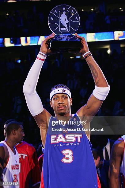 Allen Iverson of the Eastern Conference All-Stars holds up the MVP trophy as the East won 125-115 over the Western Conference in the 54th All-Star...