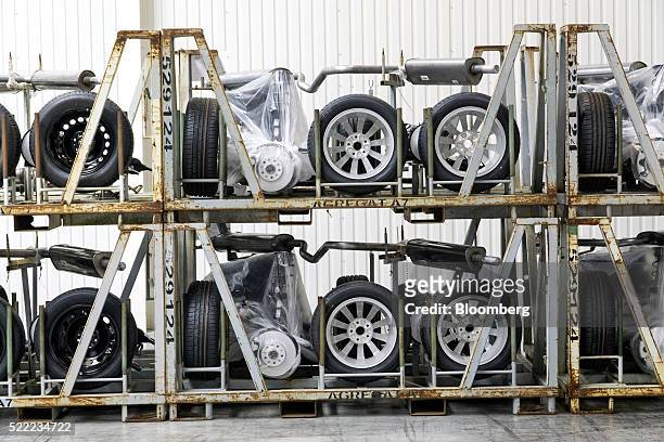 Wheel, exhaust and suspension kits for Skoda automobiles sit in racks at the Eurocar PJSC automotive plant in Solomonovo, Ukraine, on Monday, April...