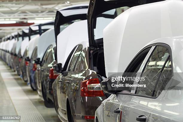 Protective wrapping covers the hoods of Skoda Superb and Octavia automobiles at the Eurocar PJSC automotive plant in Solomonovo, Ukraine, on Monday,...