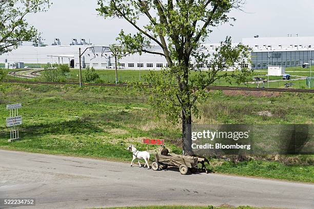 Man drives a horse and cart past the Eurocar PJSC automotive plant which assembles Skoda automobiles in Solomonovo, Ukraine, on Monday, April 18,...