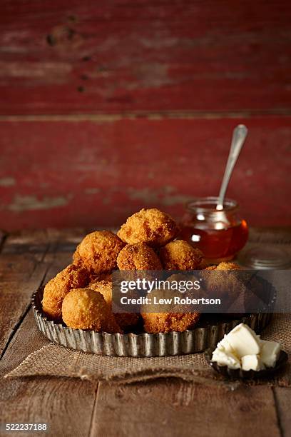 deep fried corn balls or hush puppies - kroket stockfoto's en -beelden