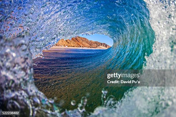 dramatic ocean wave on a pristine coastline - rip curl stock pictures, royalty-free photos & images