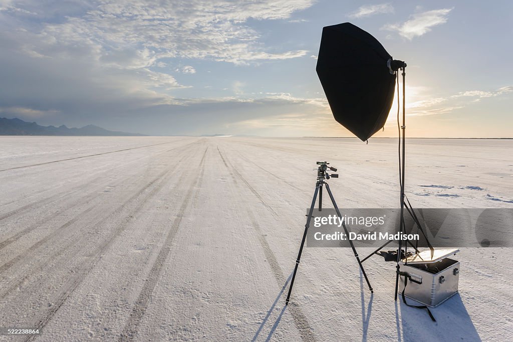 Tripod, reflector and camera gear on salt flat