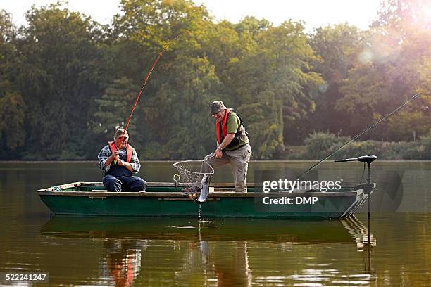 two senior man catching fish - fishing boat 個照片及圖片檔