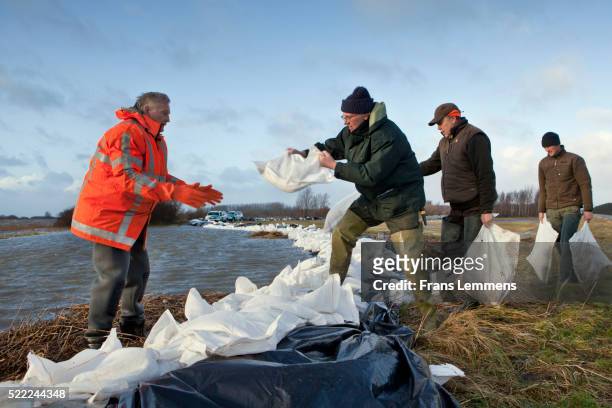 netherlands, lauwersoog, protecting land with sandbags against flooding - sandbag stock pictures, royalty-free photos & images