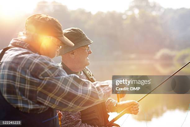 two senior men fishing on lake - lake fishing stock pictures, royalty-free photos & images