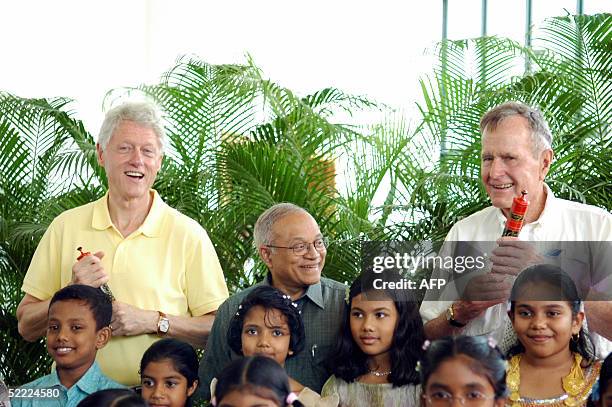 Former US Presidents Bill Clinton and George H. Bush pose for pictures with children of The Maldives and Maldives' President Maumoon Abdul Gayoom...