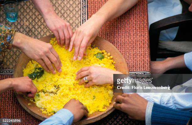 friends sharing couscous - クスクス ストックフォトと画像