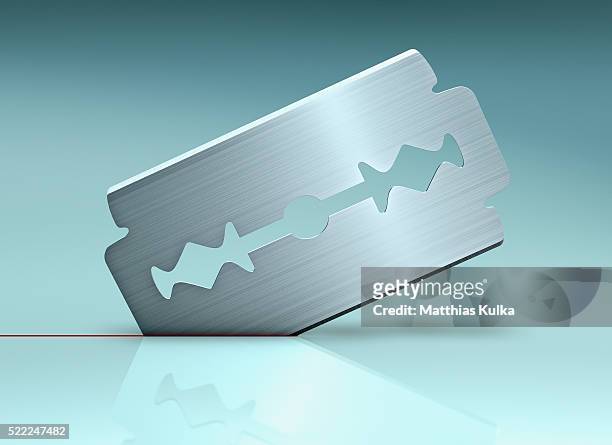 razor blade cutting through surface - razor blade stock pictures, royalty-free photos & images
