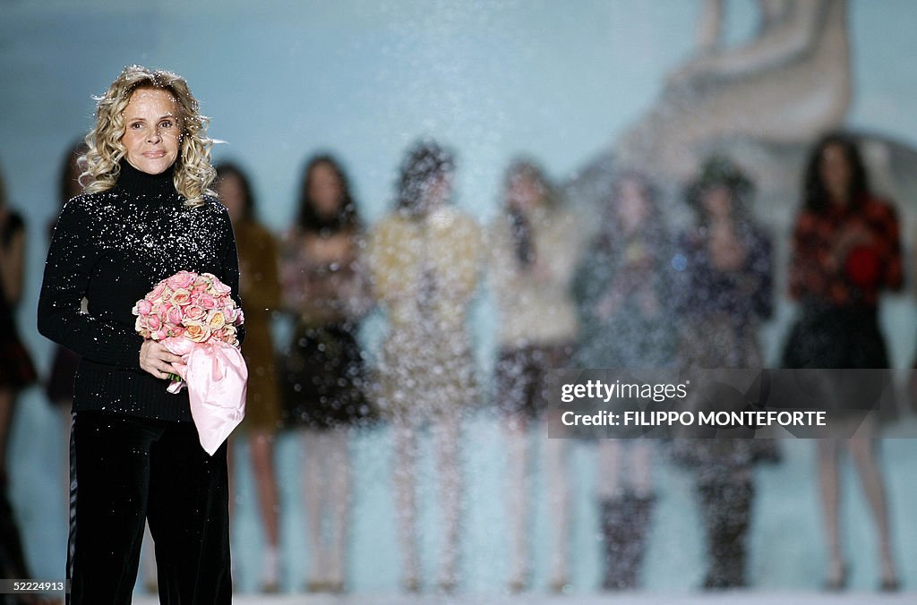 Italian designer Anna Molinari (L) holds