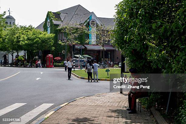 Security guard dressed in a British uniform looks at the tourists in Thames town. In the suburbs of Shanghai, there is a place called Thames Town,...