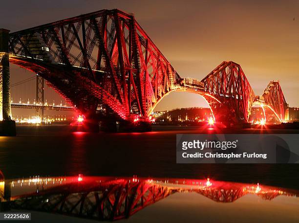 The Forth Rail Bridge is illuminated in red light to announce the start of Comic Relief fundraising, February 21 Edinburgh, Scotland. Bridge...