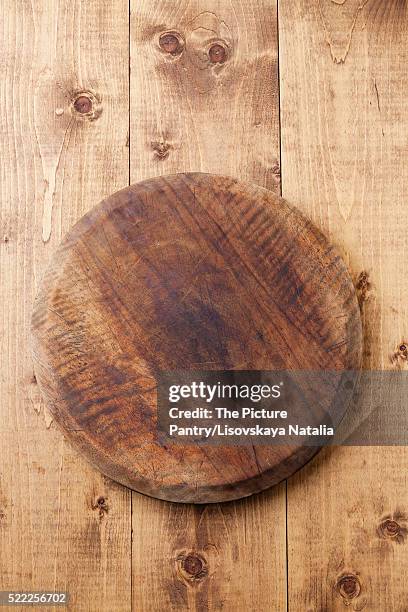 kitchen cutting board on wooden texture background - round wooden chopping board stock pictures, royalty-free photos & images