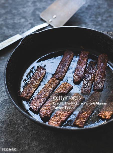 tempeh strips in a skillet - tempe stock pictures, royalty-free photos & images