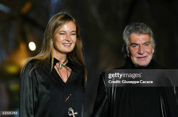 Italian designer Roberto Cavalli and his wife Eva acknowledge the applause as they walk down the runway at the Just Cavalli fashion show as part of...