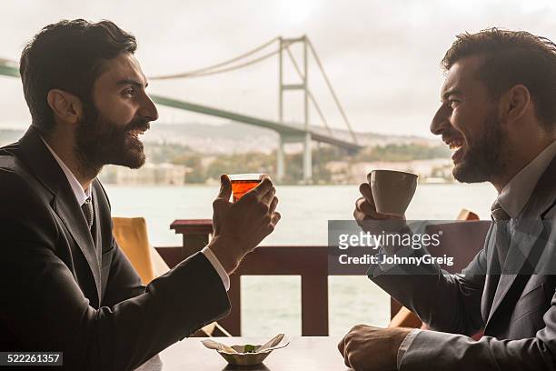 business meeting at the bosphorous bridge, istanbul. - istanbul tea stock pictures, royalty-free photos & images