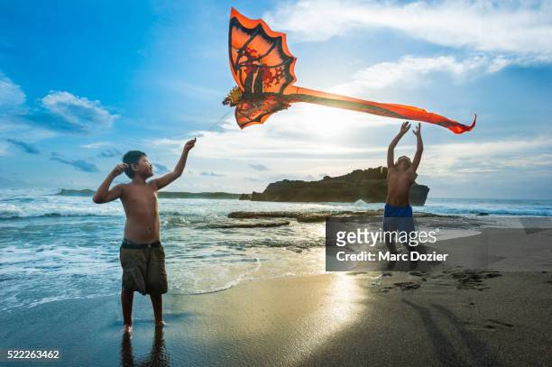 kids playing kite in bali - indonesian kite stock pictures, royalty-free photos & images