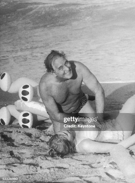 Great train robber Ronald Biggs rescues German actress Dolly Dollar from the sea in a scene from Klaus Lemke's film 'Flitterwochen' , Rio de Janeiro,...