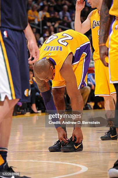 Kobe Bryant of the Los Angeles Lakers ties his official mamba day shoes during the game against the Utah Jazz at STAPLES Center on April 13, 2016 in...