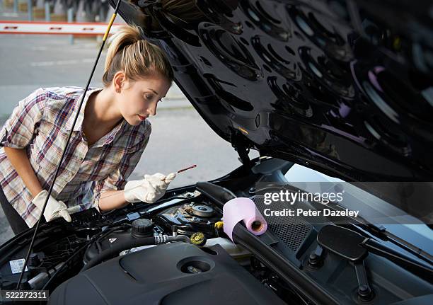 woman checking oil in car - check engine stock pictures, royalty-free photos & images