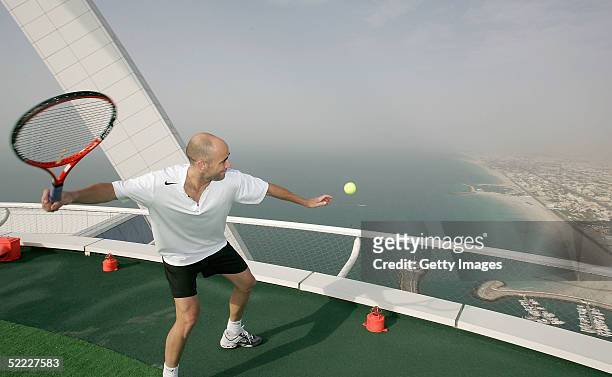 In preparation for the Dubai Duty Free Men's Open Andre Agassi hits a tennis ball from the world's most unique tennis court, the Helipad of the Burj...