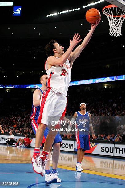 Manu Ginobili of the Western Conference All-Stars lays the ball up over Zydrunas Ilgauskas of the Eastern Conference All-Stars during the 54th...